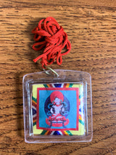 Load image into Gallery viewer, A square shaped amulet of the Loving Mother, Sherab Jamma. A red thread is attached to the amulet by a metal ringlet so it could be worn. The image of Sherab Jamma inside the amulet is colorful and decorated with thread details on the back. The amulet has smooth edges.